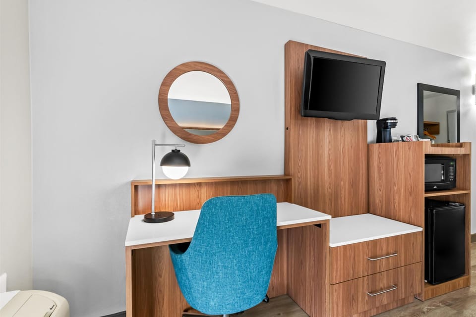 Premium bedding, desk, laptop workspace, blackout drapes