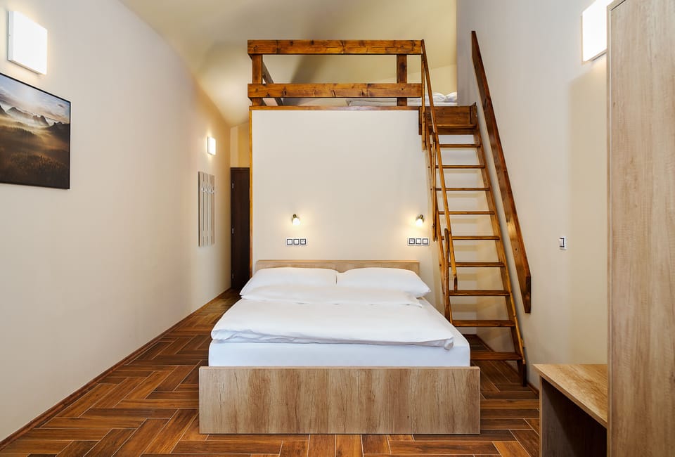 Quadruple Room | Living area | Flat-screen TV, heated floors