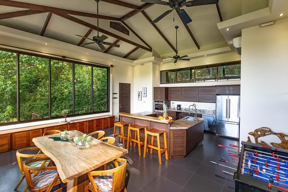 The Sky Suite open-concept kitchen and dining area surrounded by jungle views.
