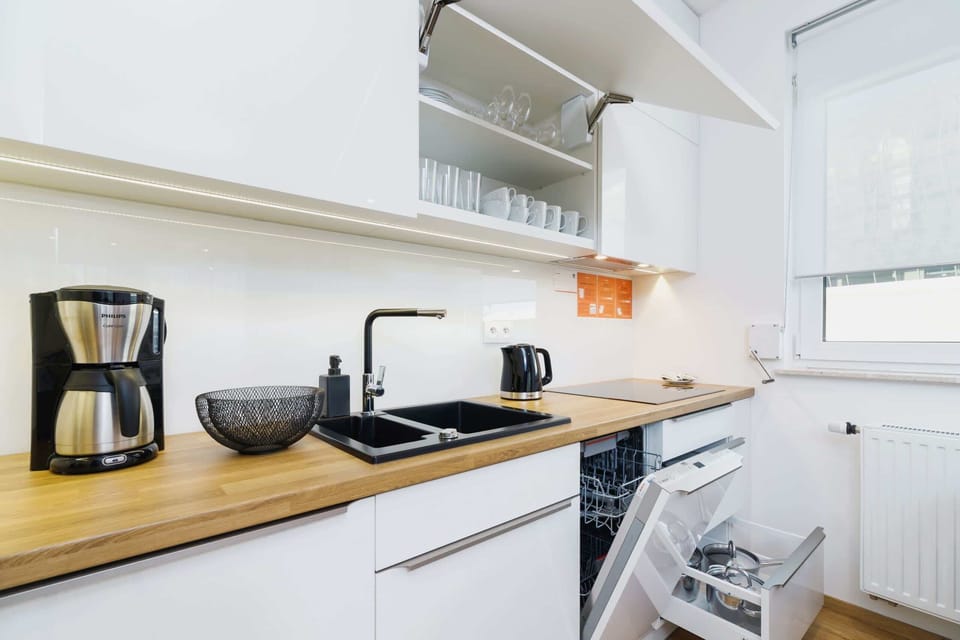 The sleek design of the kitchenette blending seamlessly with the living area.