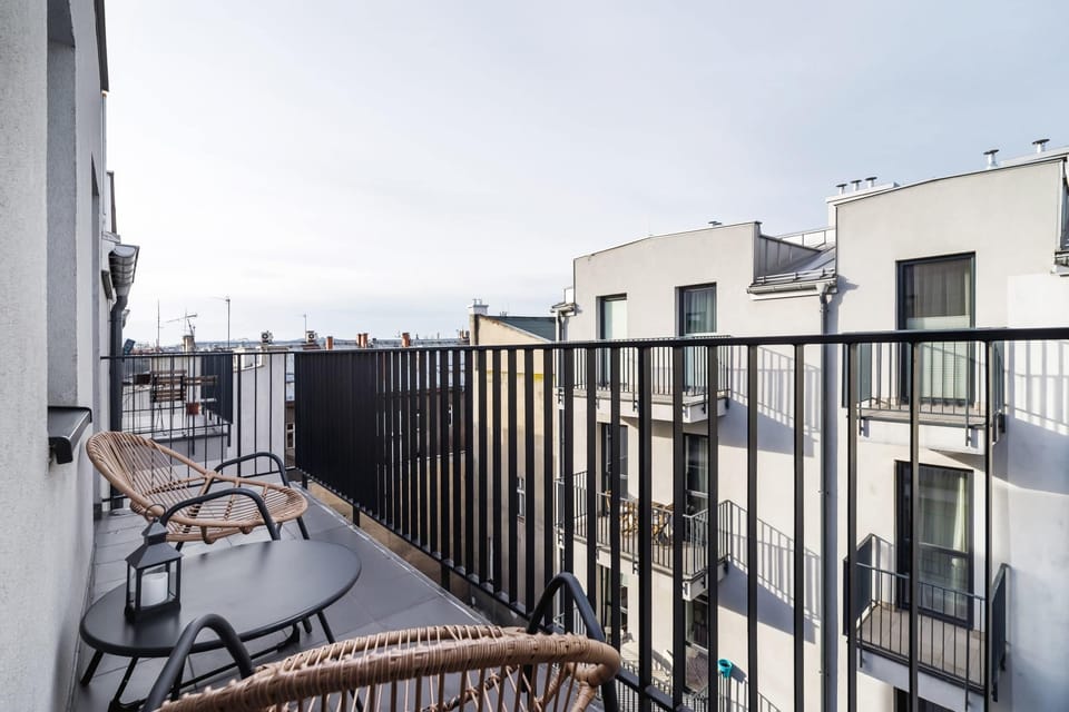 A view from a balcony overlooking a peaceful neighborhood, featuring modern outdoor railings.
