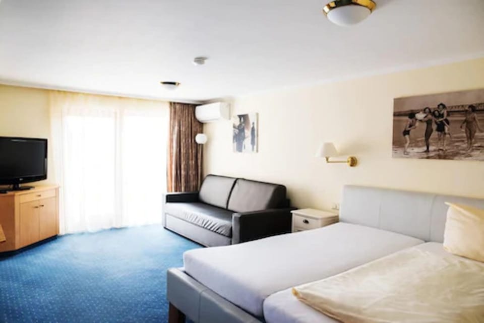Family Triple Room | Minibar, in-room safe, desk, laptop workspace
