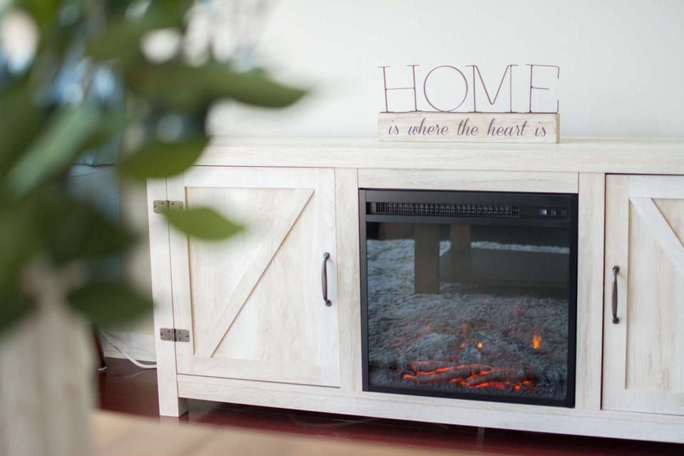 A fake flickering flame brings an ambient touch to your abode, while an electric heater helps make your living room the ideal temperature.