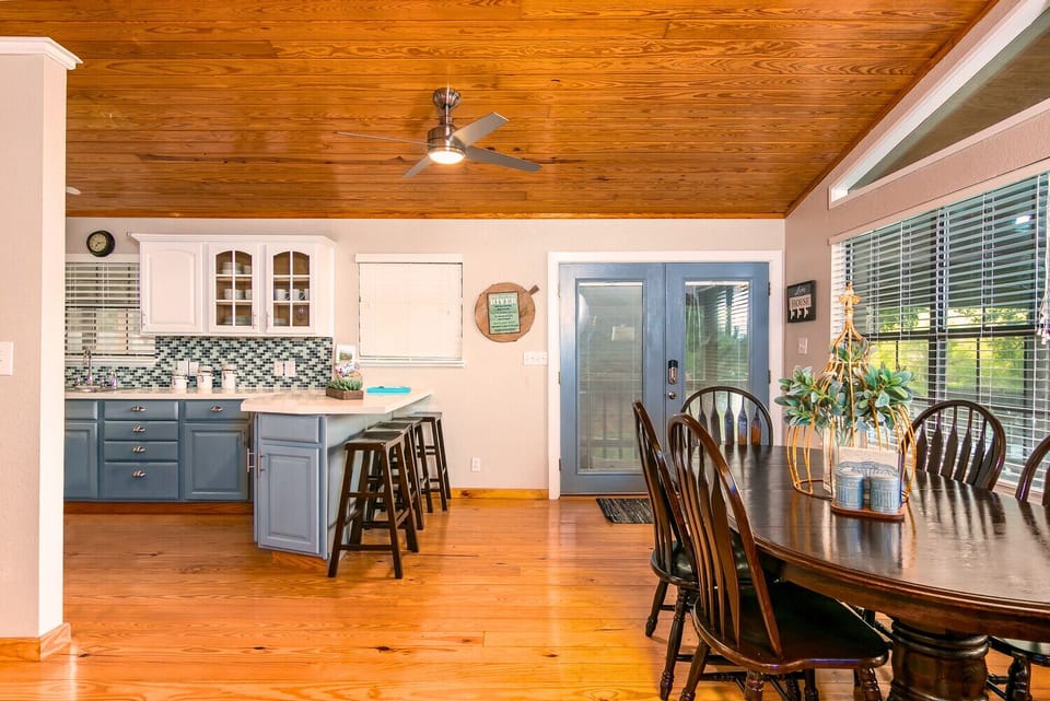 Enjoy stunning river views through a wall of windows! The open-concept kitchen and dining area features an island with seating for four, plus a dining table that comfortably seats six.