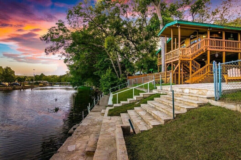 The Most Amazing View From your Private Balcony and Private Deck! Surrounded by Trees Step outside to the riverside vacation with our home's direct river access. The exterior shot captures the tranquil ambiance, promising a peaceful and unforgettable stay and amazing view right from your private balcony! 