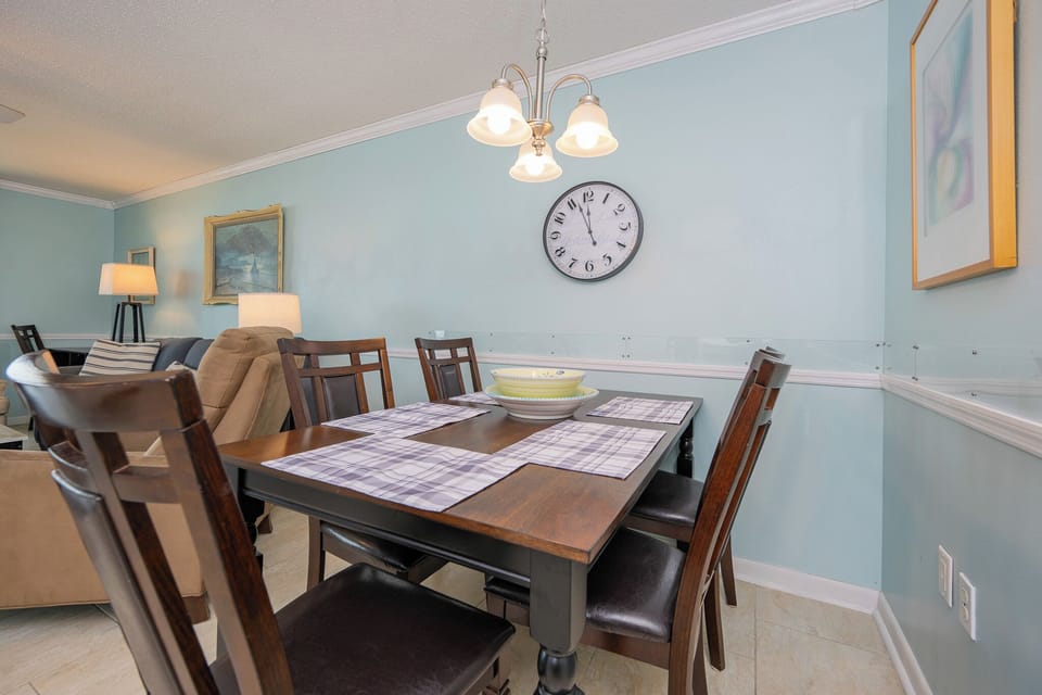 Gather your family around the dining table, savoring laughter and warmth under the charming light fixture