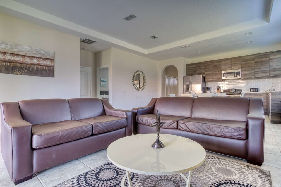 Spacious Living Area w/Leather Sofas, Wall Mounted TV and Pool Access