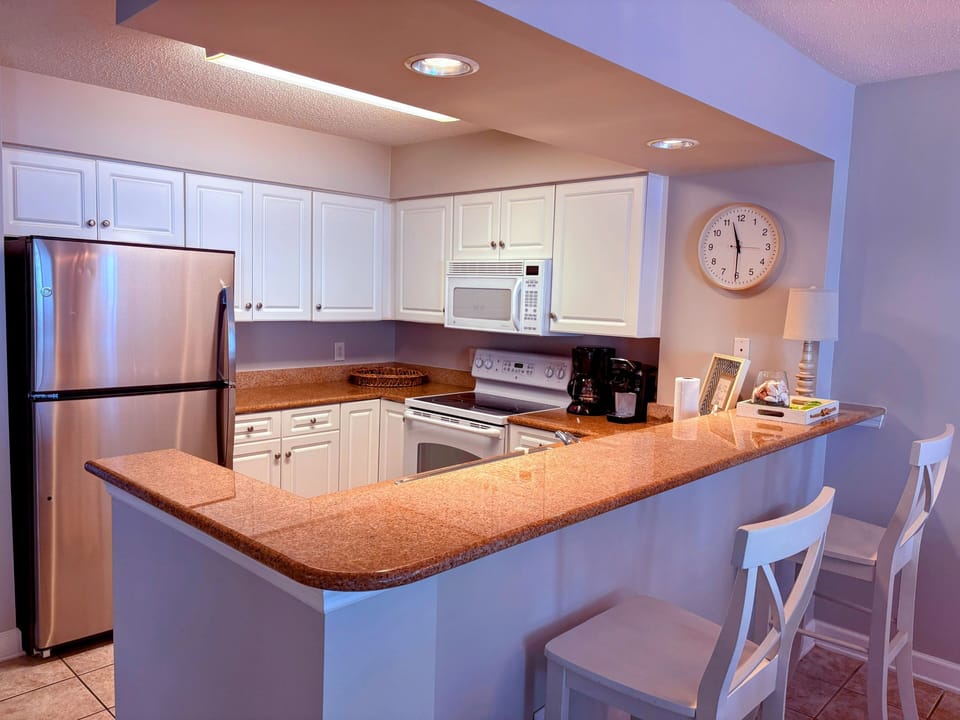 Refrigerator with ice maker and microwave