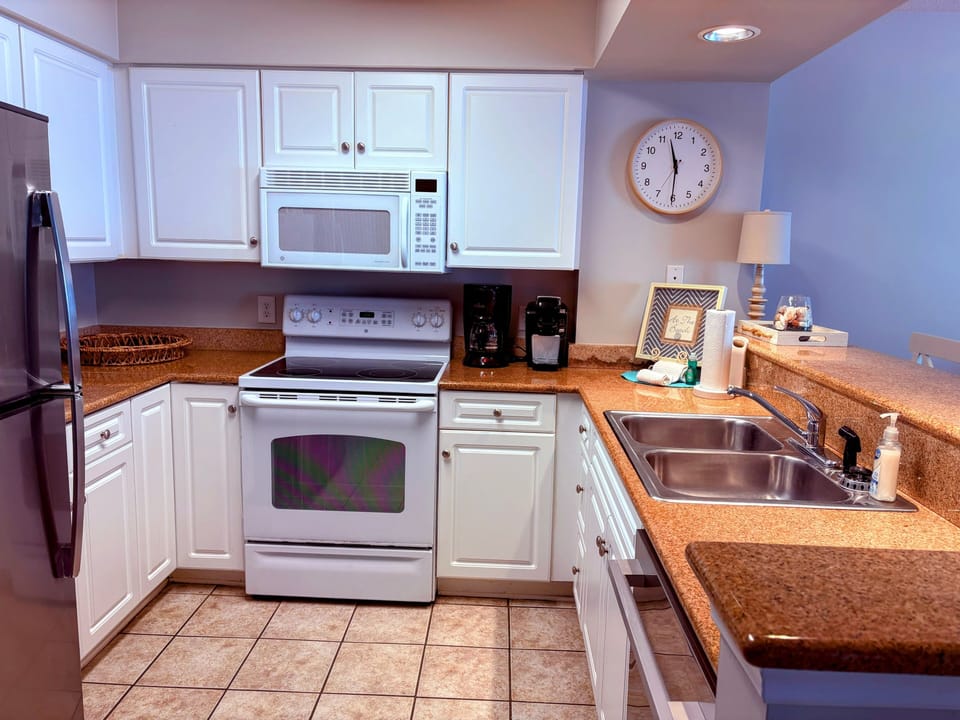 Kitchen stocked with all needed cookware, dishes, glassware and utensils.