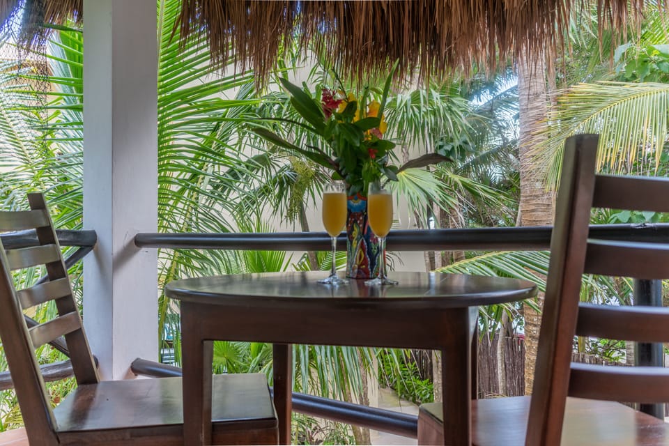 Upper deck overlooking lush tropical grounds.