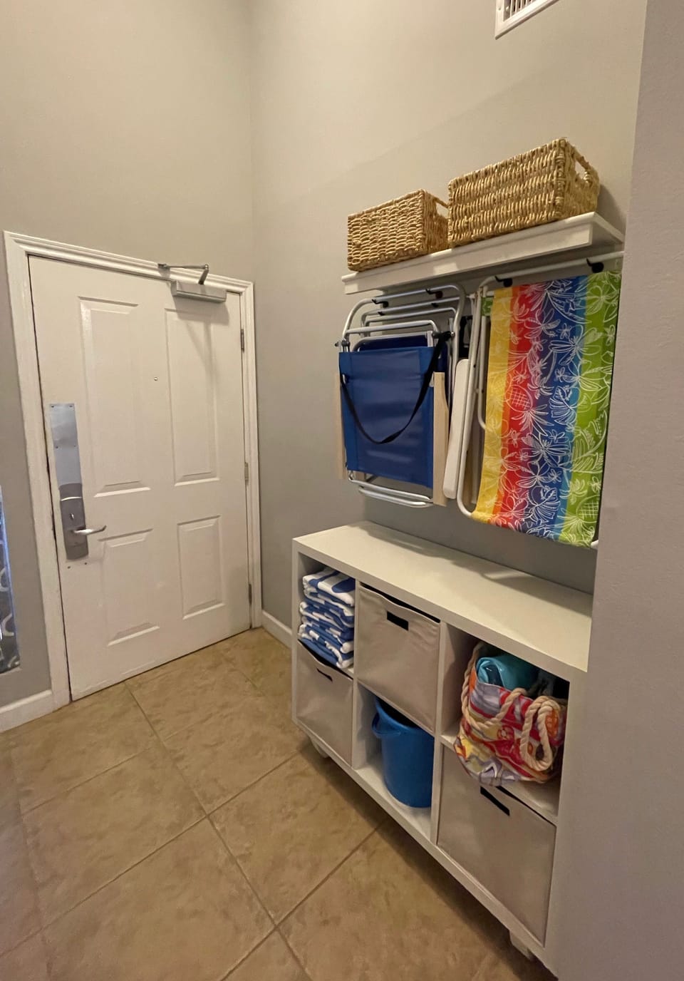 Entry with beach towels, chairs, umbrellas, etc.
