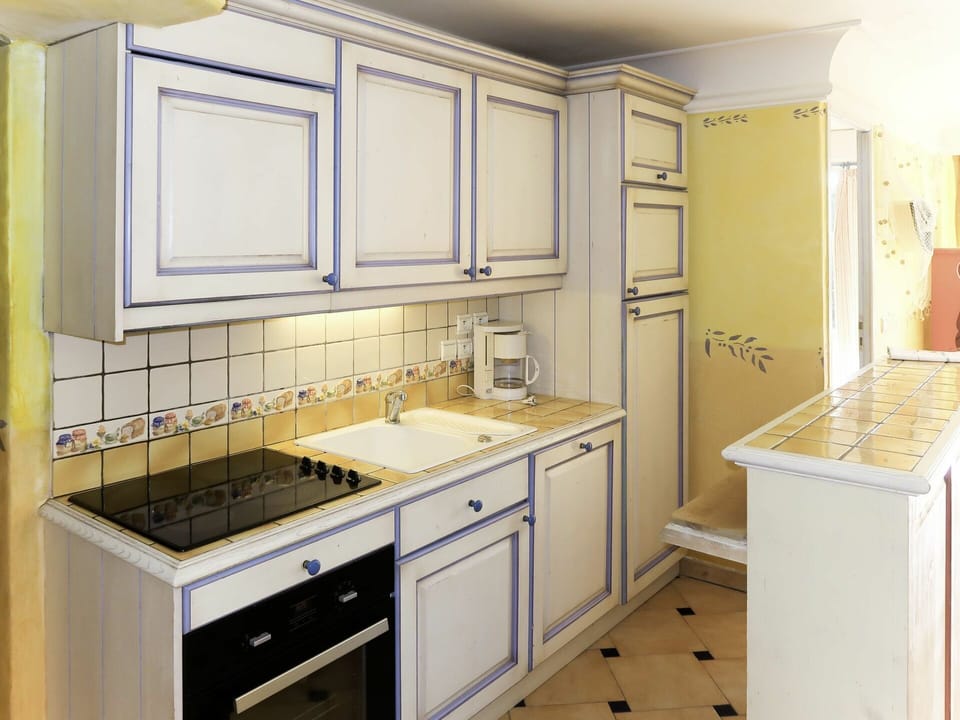 Cabinetry, Room, Countertop, Furniture, Property, Kitchen, Sink, Interior Design, Yellow, Tile