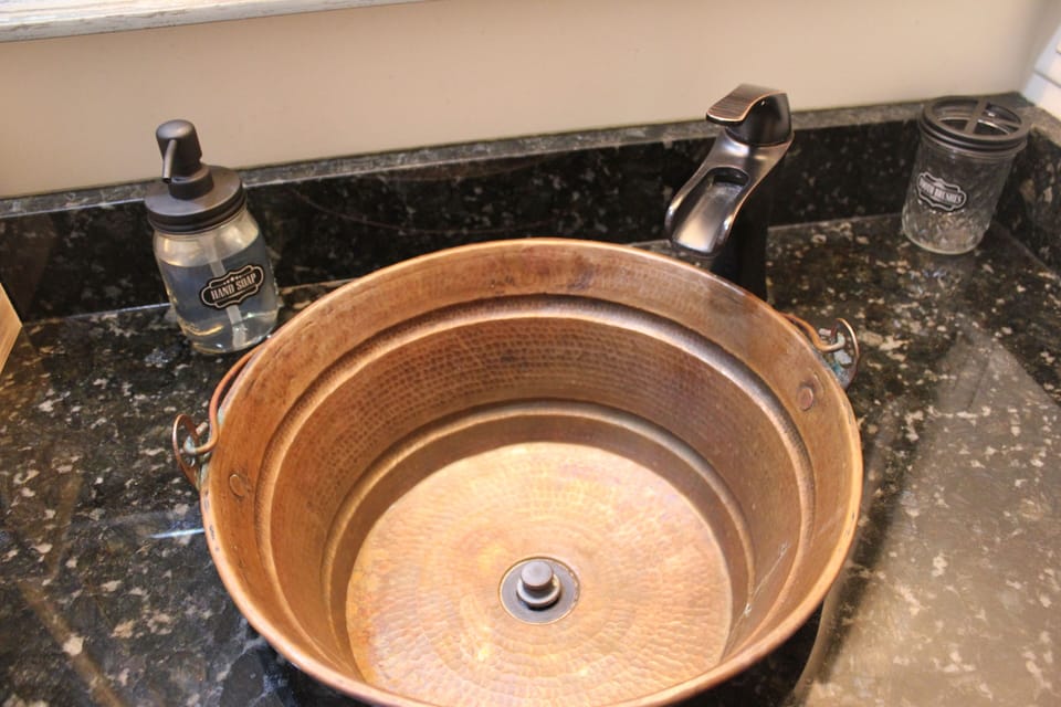 Copper bucket sink with oil rubbed bronze vessel faucet