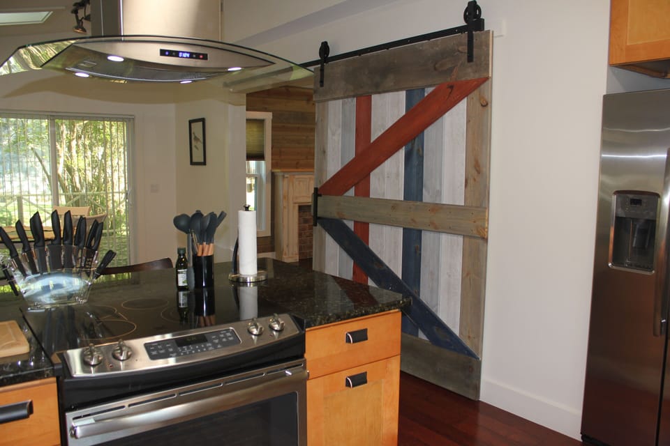 Barn door for closing off living room when used as a bedroom with sleeper sofa.