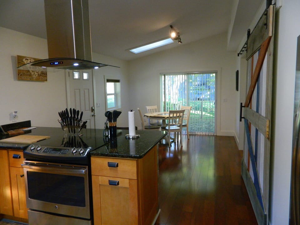 Dining area has sliding glass door that opens onto a deck