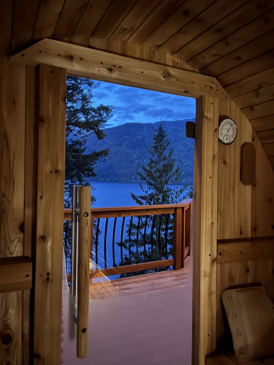 Sauna with a view of lake at dusk