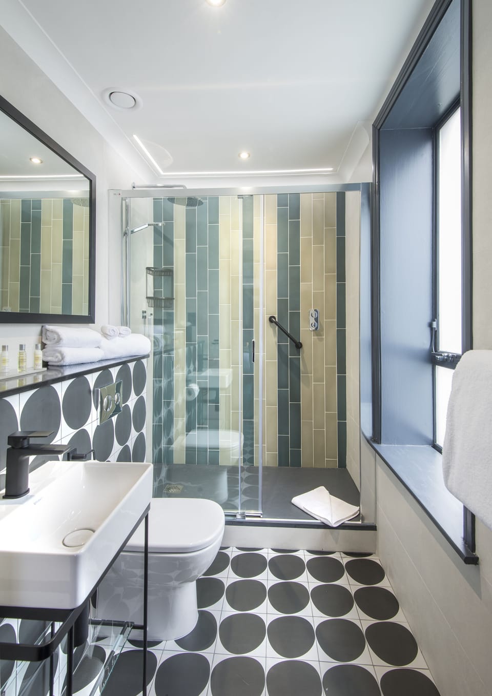 Shower, rainfall showerhead, hair dryer, towels
