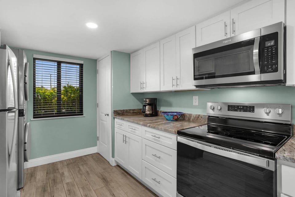 Newly renovated kitchen with stackable washer/dryer combo.