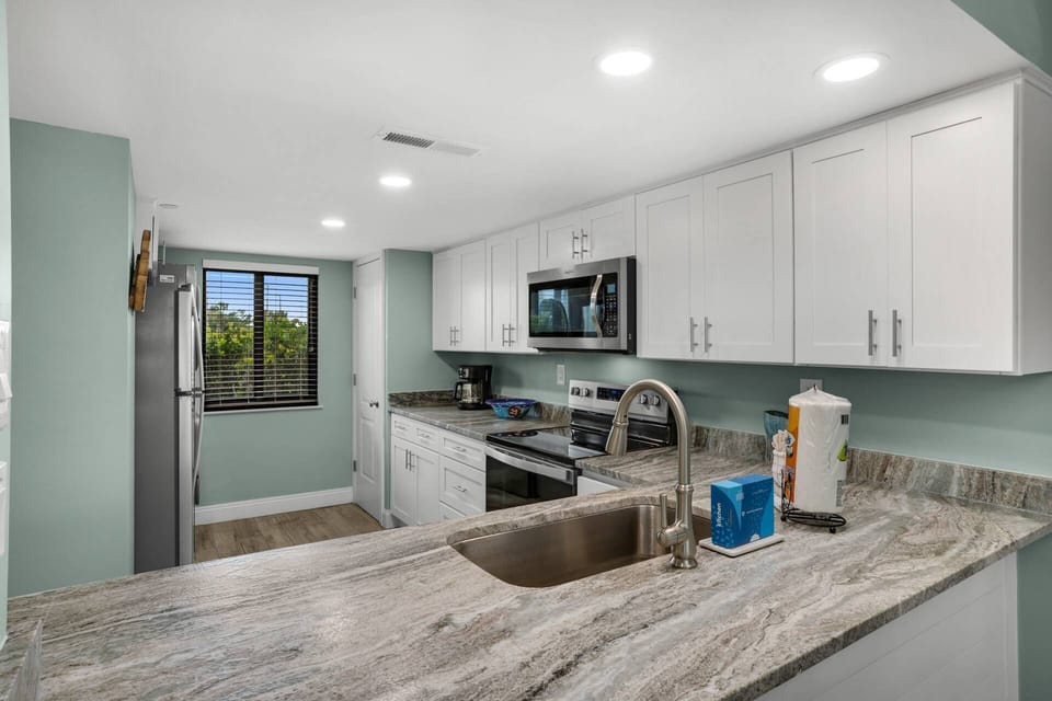 Leathered granite countertops and modern cabinets will make you feel right at home.