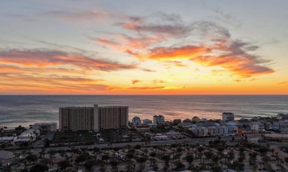 The Gulf Coast lights up in orange and pink — another perfect Panama City Beach sunset from The Commodore.