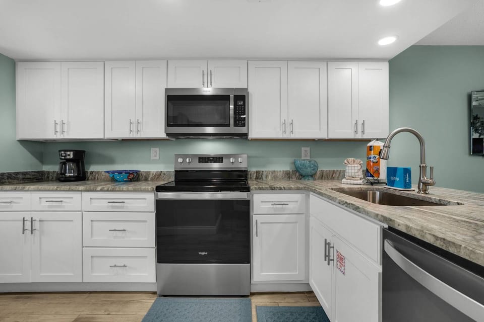Kitchen is fully equipped with modern stainless steel appliances.