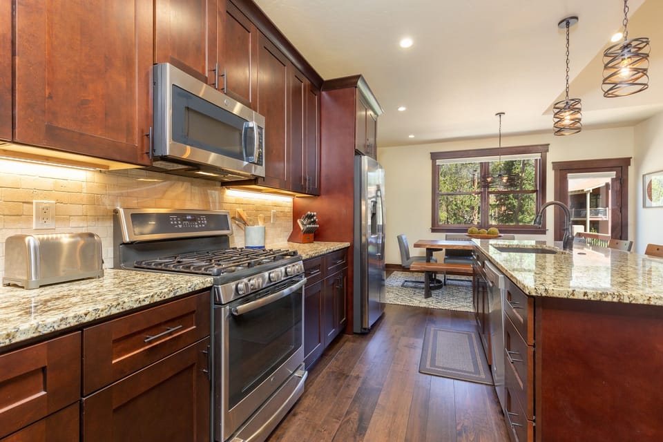 Your gourmet kitchen features granite countertops, rich cherry cabinets, and stainless steel appliances for memorable cooking experiences.