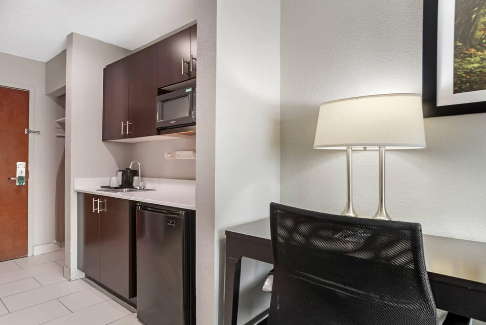 Suite, 1 King Bed, Non Smoking | Desk, laptop workspace, blackout drapes, iron/ironing board