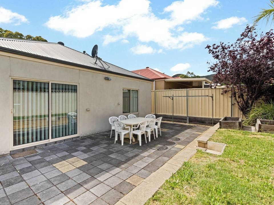 Private backyard with table and chairs to get some fresh air and sunshine.
