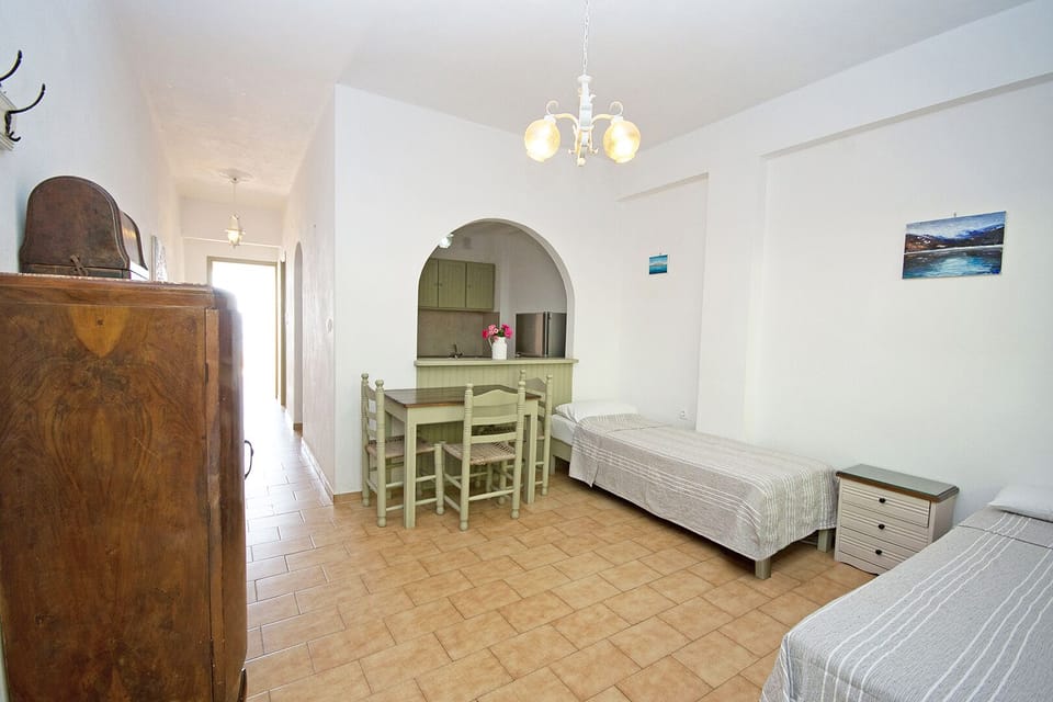 Family Apartment, 1 Bedroom, Sea View | Living area | 17-inch TV with satellite channels
