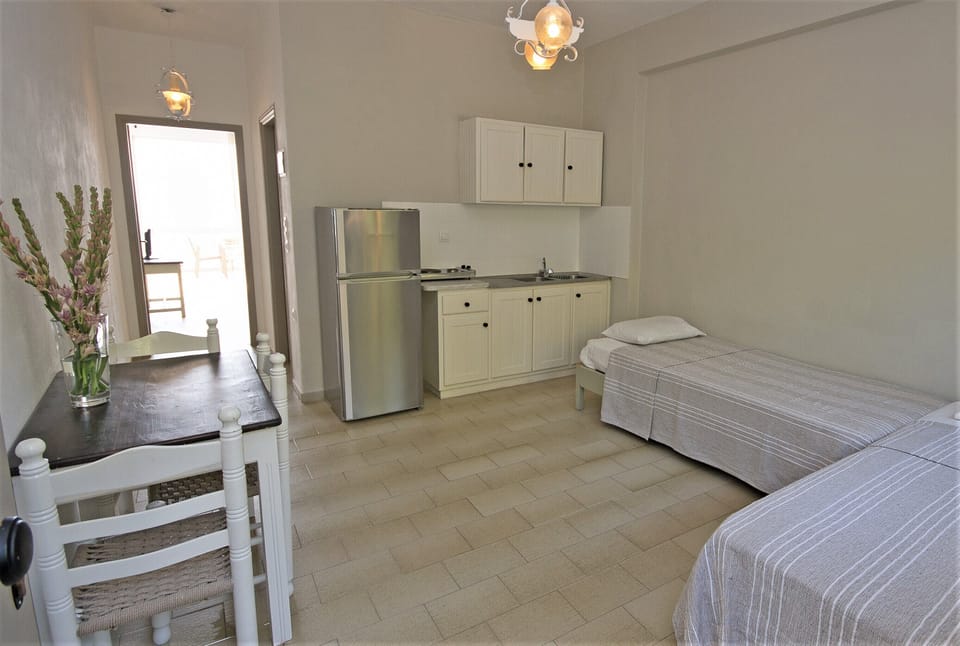 Family Apartment, 1 Bedroom, Sea View | Living area | 17-inch TV with satellite channels