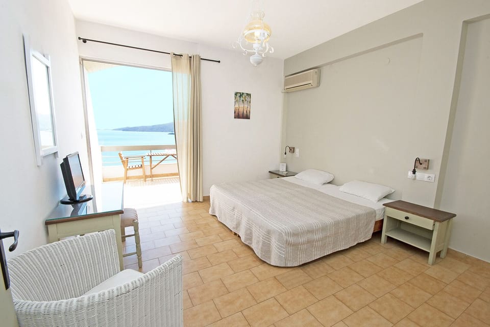 Family Apartment, 1 Bedroom, Sea View | Living area | 17-inch TV with satellite channels