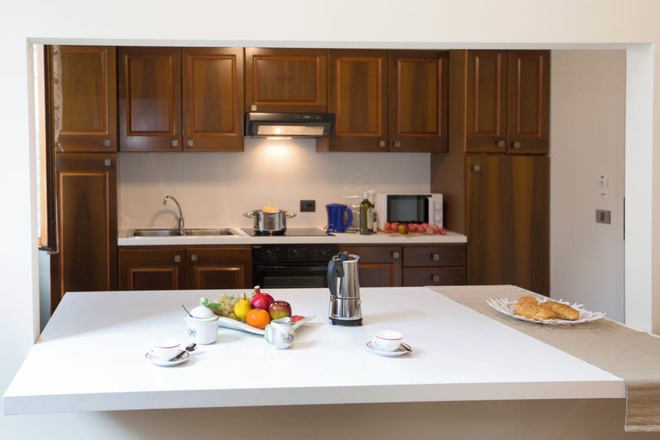 Family Apartment, Multiple Bedrooms (Appartamento Città Riva) | Private kitchen | Full-size fridge, microwave, oven, stovetop