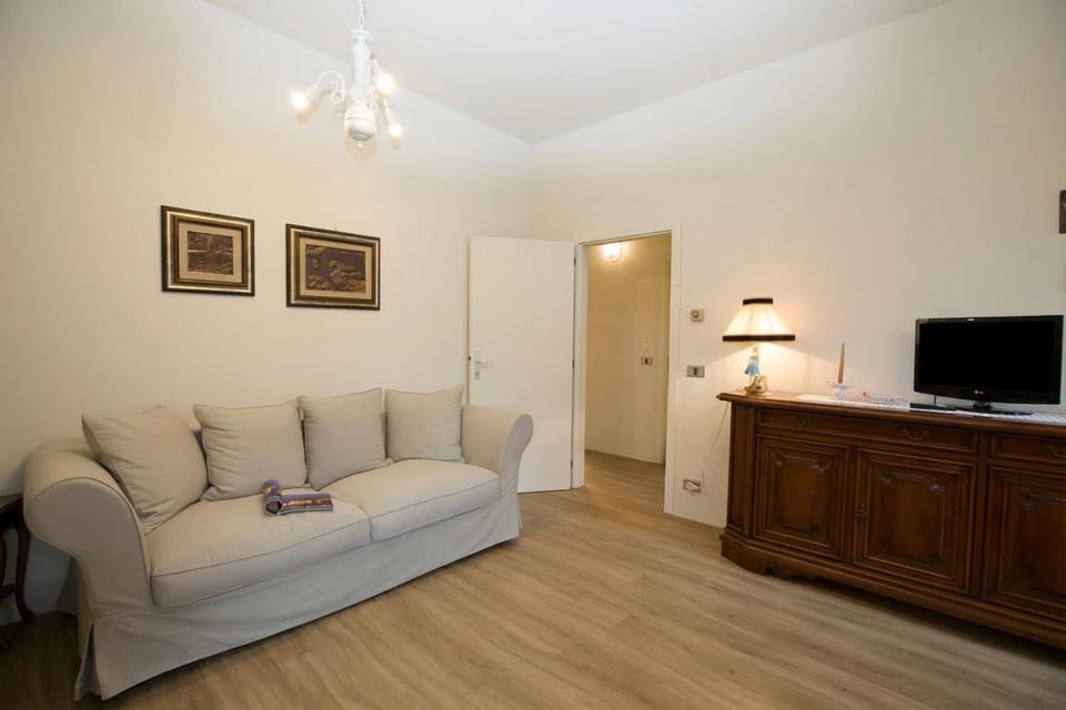 Family Apartment, Multiple Bedrooms (Appartamento Città Riva) | Living area | Flat-screen TV