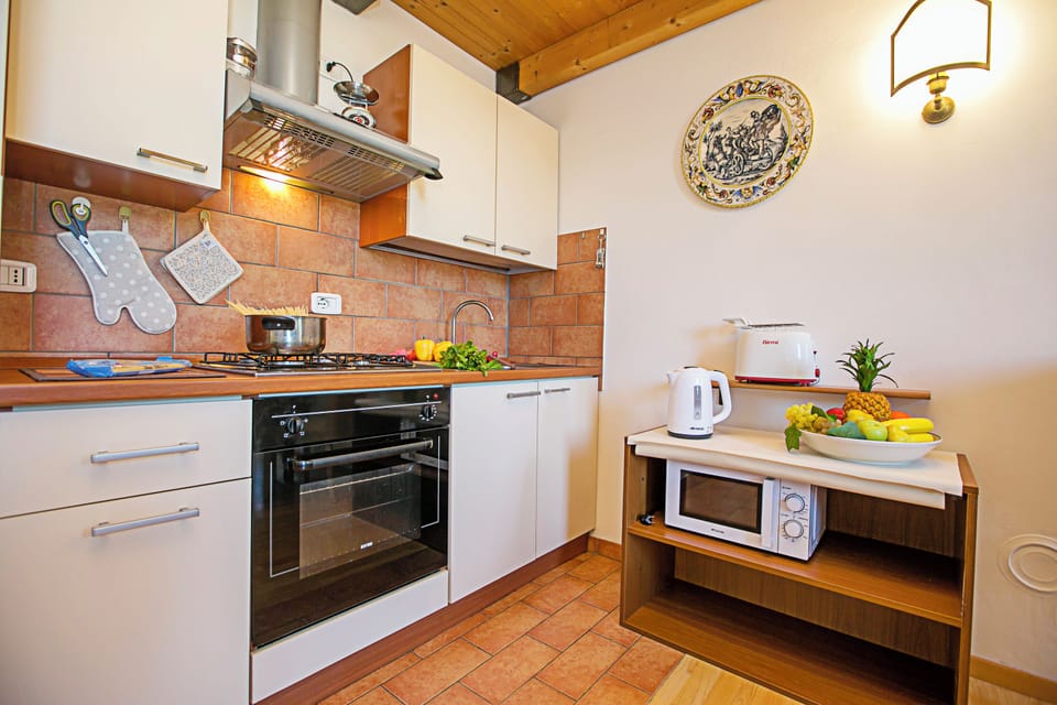 Family Apartment, Multiple Bedrooms (Appartamento Villa Lina) | Private kitchen | Full-size fridge, microwave, oven, stovetop