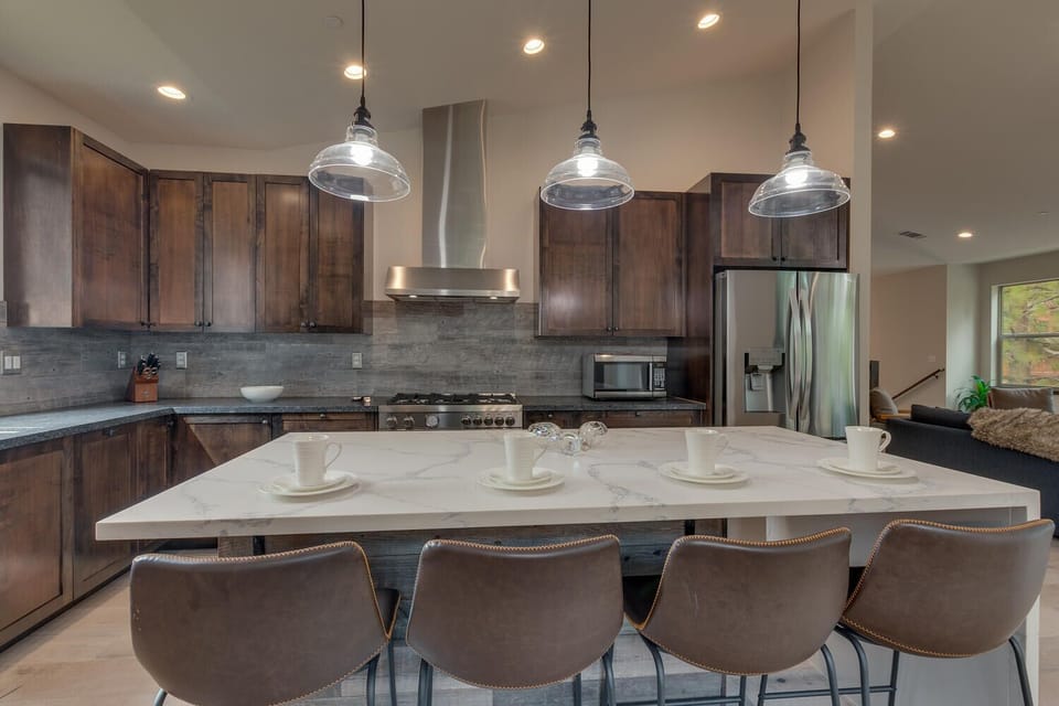 - Stylish kitchen with pendant lighting above island  
- Four leather barstools create a cozy breakfast bar  
- Perfect for entertaining after Lake Tahoe adventures