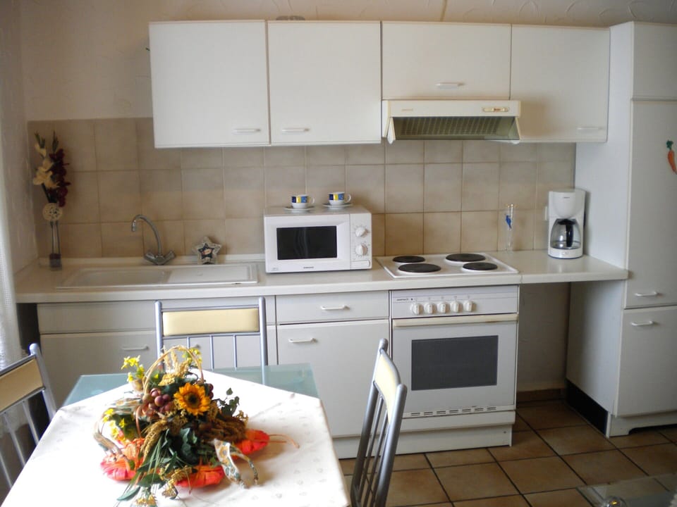 Apartment | Private kitchen | Stovetop, coffee/tea maker, highchair
