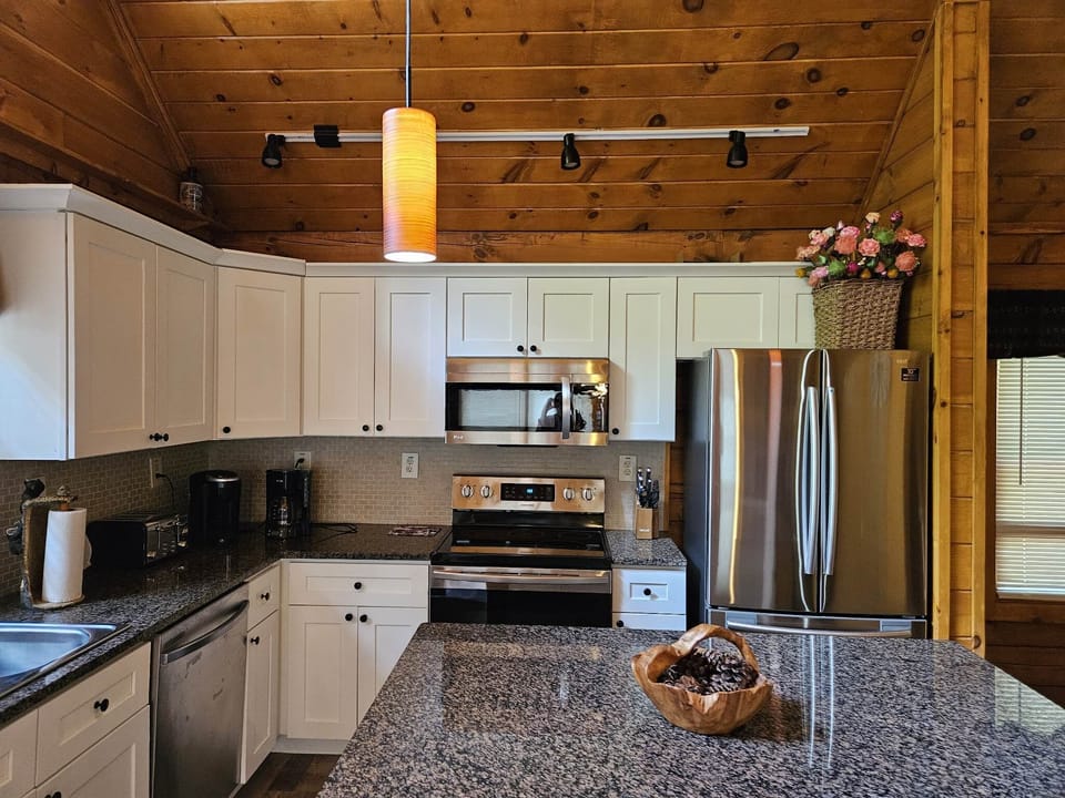 Spacious Well Furnished Kitchen.  Kitchen Island seats two.  On left front door