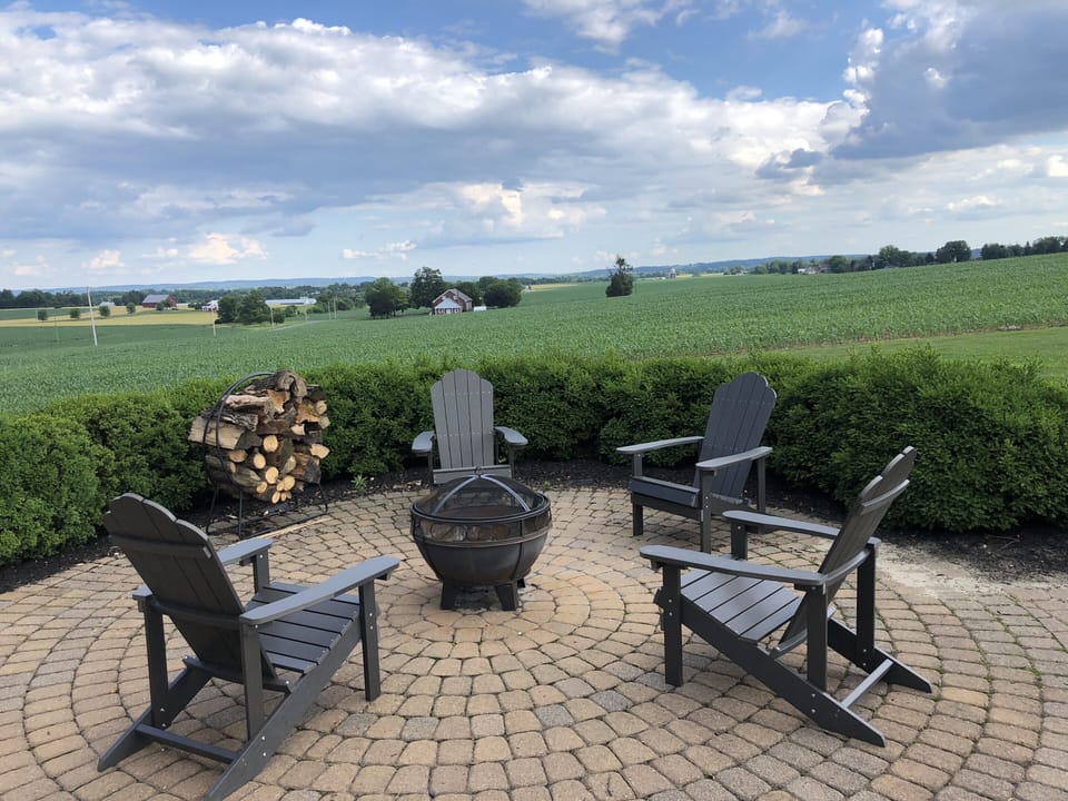 The back patio is the perfect place to watch the sunset beside a fire.