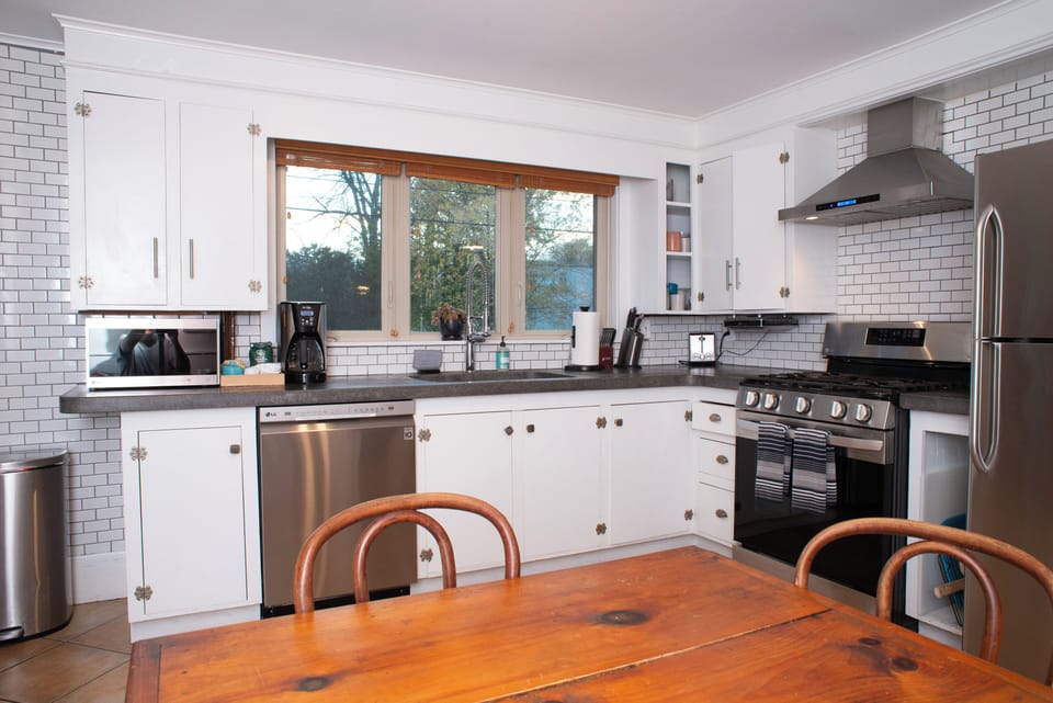 Fully stocked kitchen with cookware, bakeware, and appliances