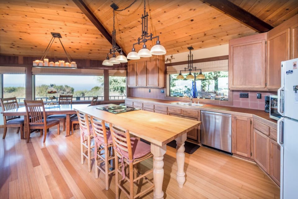 Custom butcher block center island with stove & seating. Tons of counter space