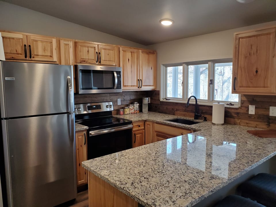 Kitchen includes stainless steel  appliances. 