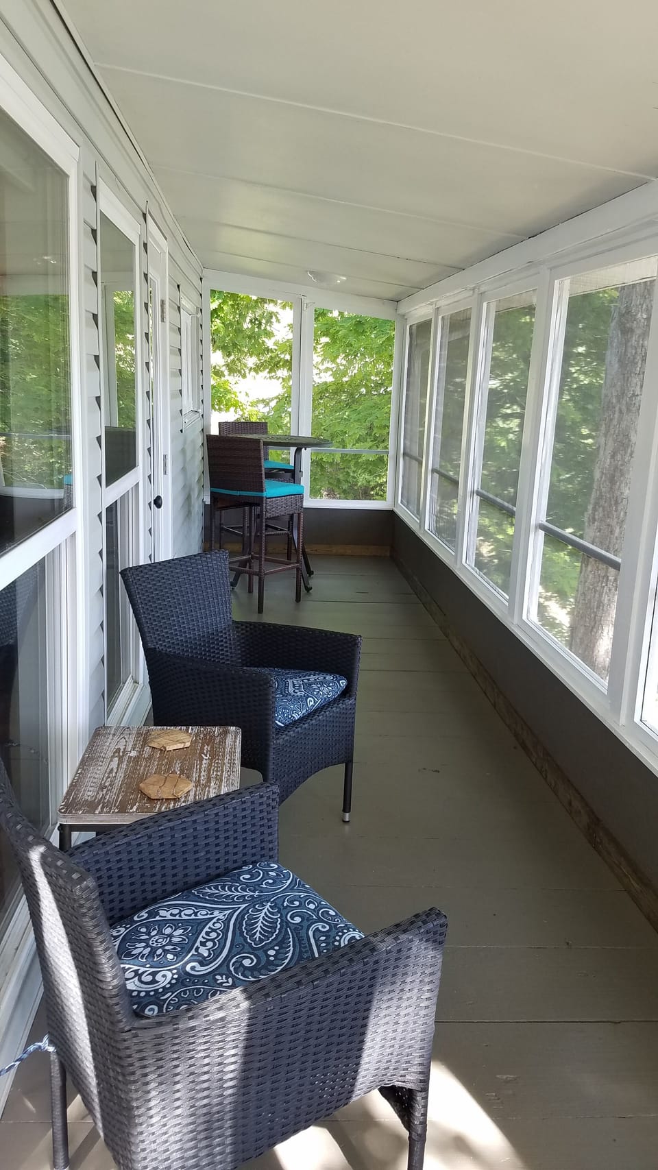 Screened in patio seating area.   Enjoy morning coffee overlooking the lake. 