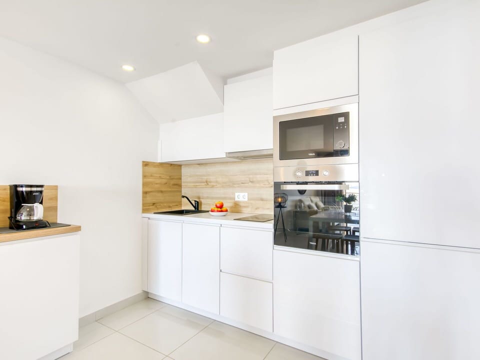 Kitchen, Interior Design, Flooring, Countertop, Wood, Kitchen Appliance, Cabinetry, Floor, Major Appliance, Ceiling
