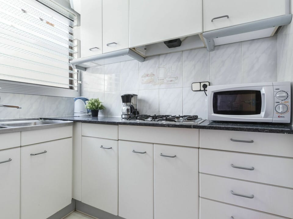 Countertop, Cabinetry, Kitchen, Room, White, Property, Furniture, Tile, Interior Design, Kitchen Stove