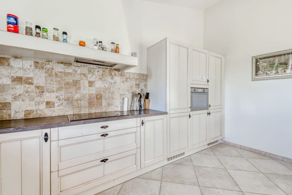 Villa | Private kitchen | Fridge, highchair