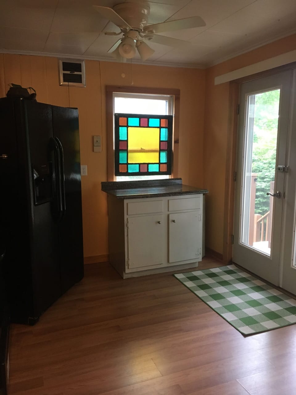Kitchen w newer appliances and river view thru sliding door that leads to deck