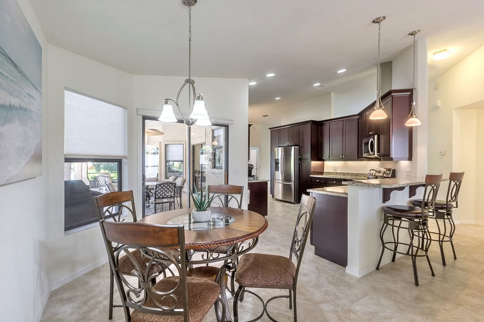 Kitchen table and breakfast bar seating for six.