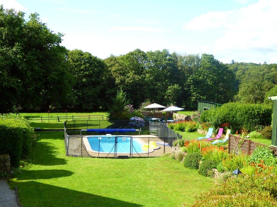 View over the pool and gardens, with our field beyond