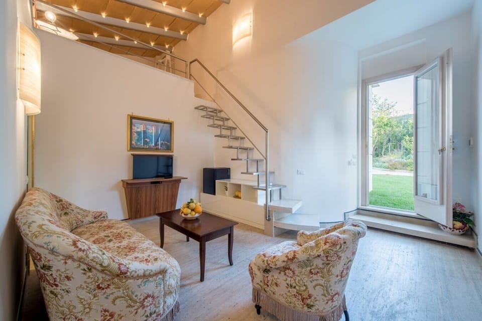 Executive Loft | Living area | 32-inch Smart TV with satellite channels, TV