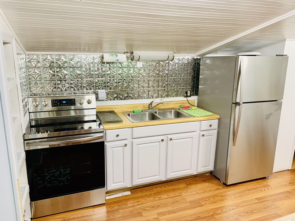 Kitchen with all new stainless appliances, large oven and five burner stovetop